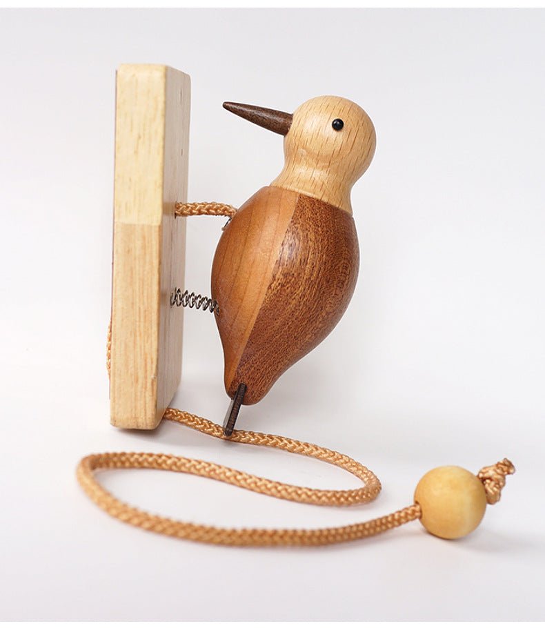 Wooden desk ornament placed on a tabletop as a funny desk gadget