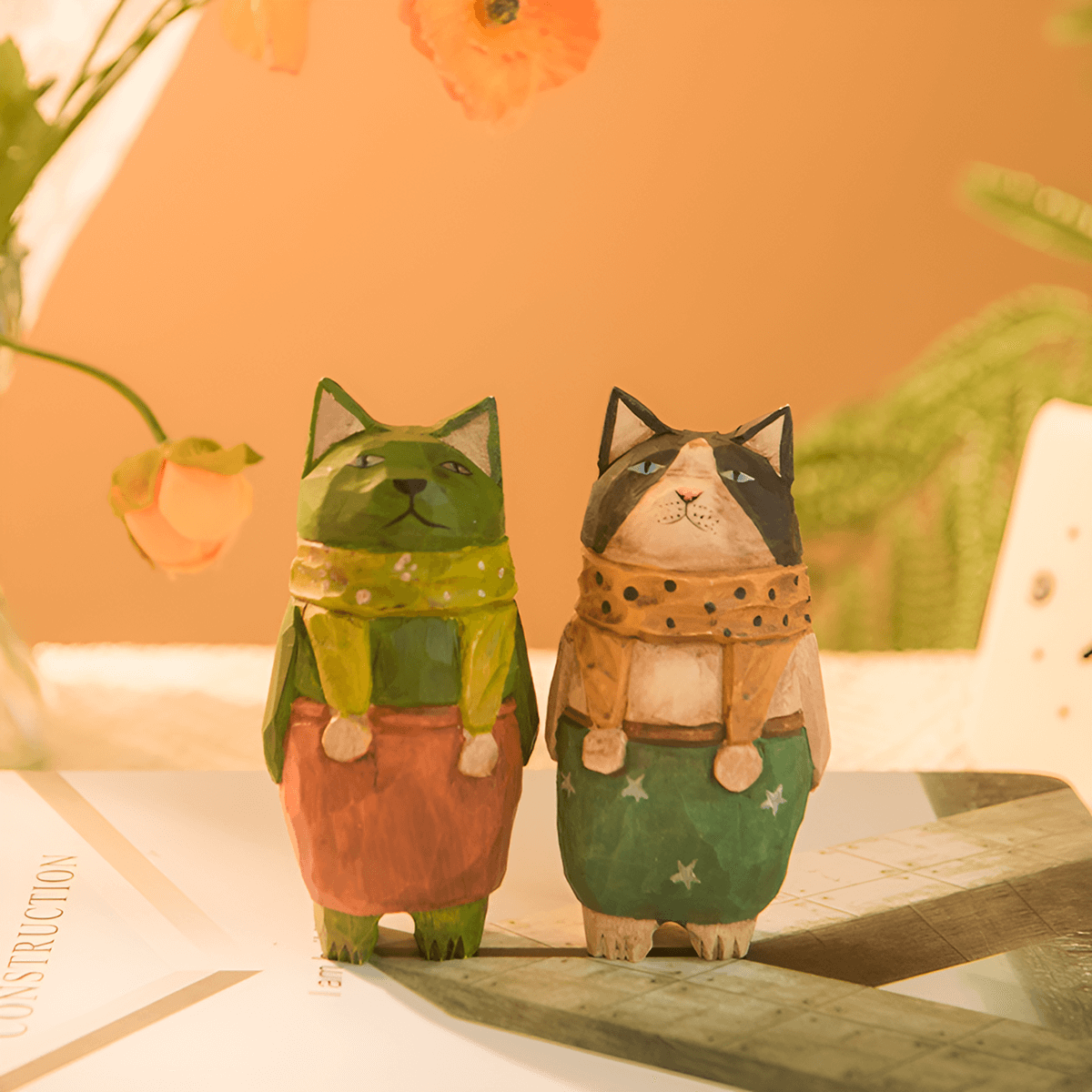 Multicolored cat figurines displayed on a desktop surface