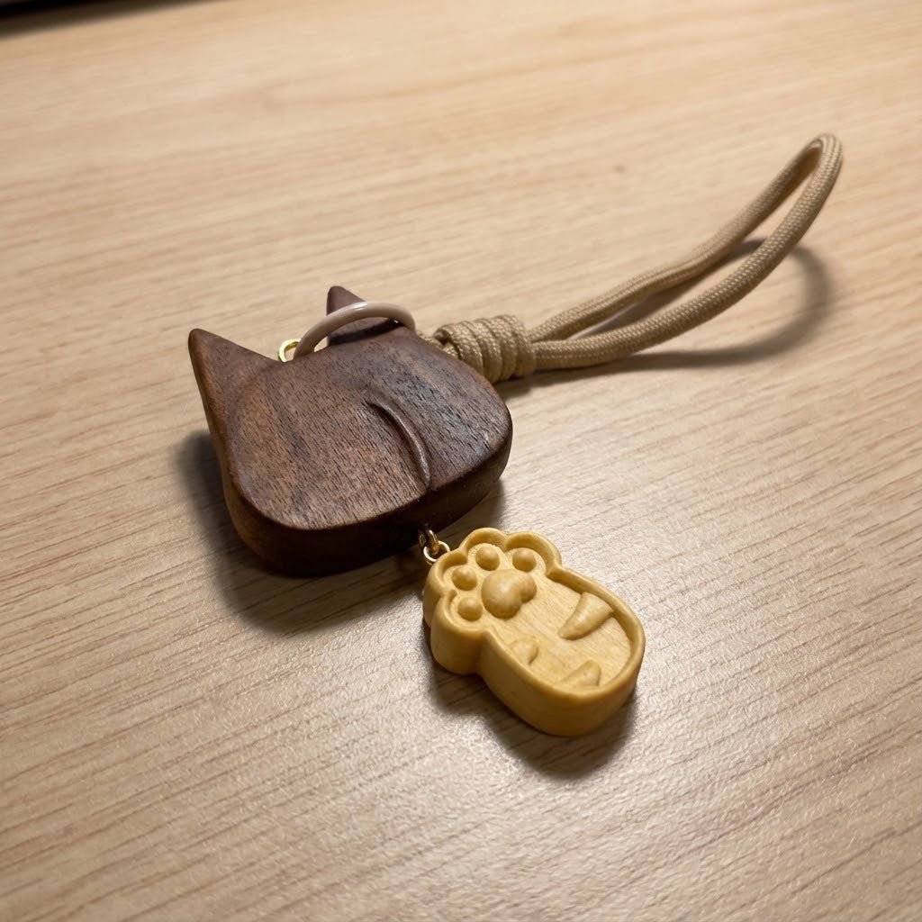 Back view of a wooden cat charm made from walnut wood