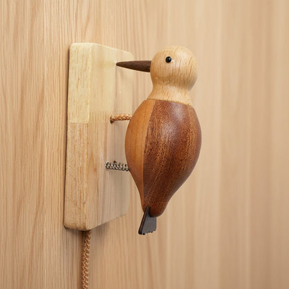 Wooden woodpecker wall ornament mounted on a wall