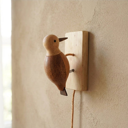 Close-up of a wooden woodpecker wall ornament showing a smooth polished surface
