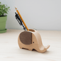 Wooden elephant pen holder placed on a desk
